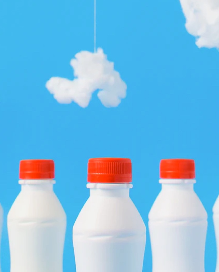 picture of milk bottles on a blue background with clouds